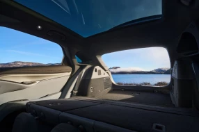 Innenansicht von vorne nach hinten in den vergrößerten Kofferraumeines Autos und raus in die Winterlandschaft.