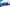 Blauer Opel Astra vor einer weißen Betonwand, seitlich frontal.