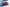 Roter Opel Corsa zwischen zwei weißen überdimensionierten Bassboxen, frontal-seitlich.