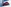 Roter Opel Corsa zwischen zwei weißen überdimensionierten Bassboxen, frontal-seitlich.