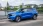 Blauer Opel Frontera auf einer städtischen Brücke, seitlich fotografiert.
