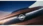 Detailaufnahme der Front eines kupferfarbenen Autos mit beleuchtetem Logo.