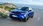 Blauer Opel Mokka fährt vor einem Meerespanorama.