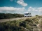 Ein Etrusco Wohnmobil fährt auf einer Landstraße durch Steppenlandschaft.