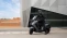 Mann sitzt auf Peugeot Motorrad, bereit zur Abfahrt.